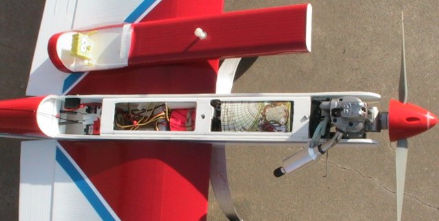  From front to back: fuel tank (under padding), throttle servo (barely visable), receiver on top of battery (orange), spar passing through fuse, elevator/rudder servos.