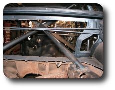  Rear support bars welded to shock towers, view from trunk.
